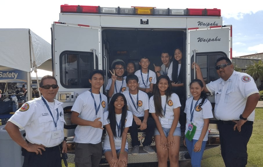 Junior Paramedics posing in front of ambulance