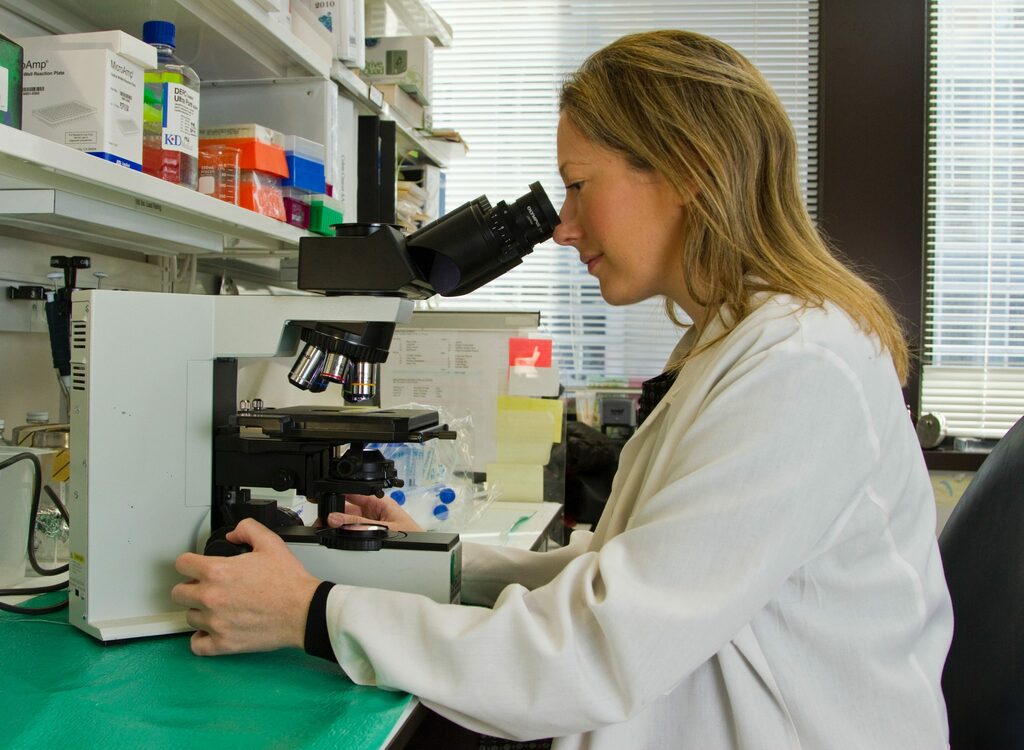 Woman looking in microscope